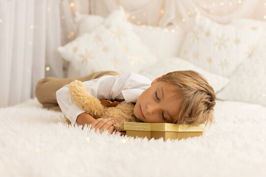 Happy child on Christmas, enjoying some quality time, opening presents, kids on Christmas eve in decorated home