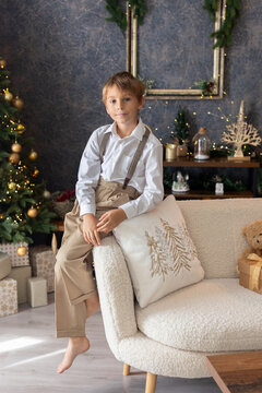 Happy child on Christmas, enjoying some quality time, opening presents, kids on Christmas eve in decorated home
