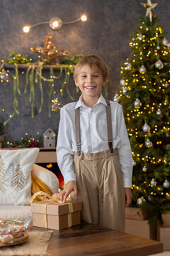 Happy child on Christmas, enjoying some quality time, opening presents, kids on Christmas eve in decorated home