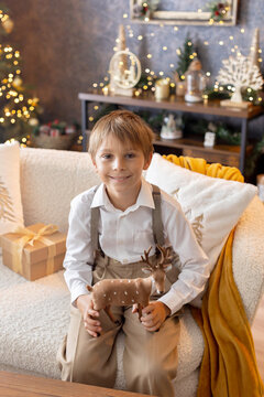 Happy child on Christmas, enjoying some quality time, opening presents, kids on Christmas eve in decorated home
