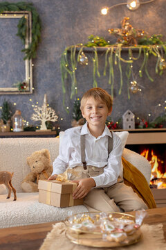 Happy child on Christmas, enjoying some quality time, opening presents, kids on Christmas eve in decorated home