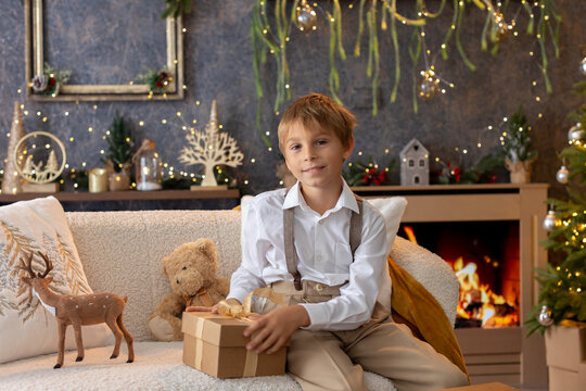 Happy child on Christmas, enjoying some quality time, opening presents, kids on Christmas eve in decorated home