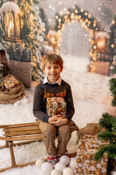 Happy child on Christmas, enjoying presents, snow, christmas lights and enjoying the day