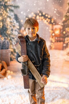 Happy child on Christmas, enjoying presents, snow, christmas lights and enjoying the day