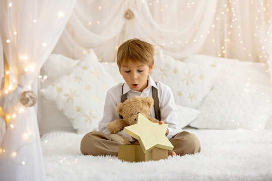 Happy child on Christmas, enjoying some quality time, opening presents, kids on Christmas eve in decorated home