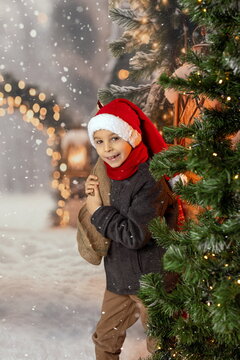 Happy child on Christmas, enjoying presents, snow, christmas lights and enjoying the day