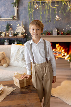 Happy child on Christmas, enjoying some quality time, opening presents, kids on Christmas eve in decorated home