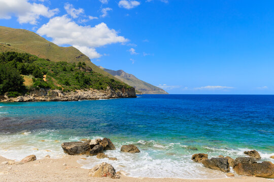Scenic Mediterranean coast with turquoise waters and rugged mountains under a clear sky