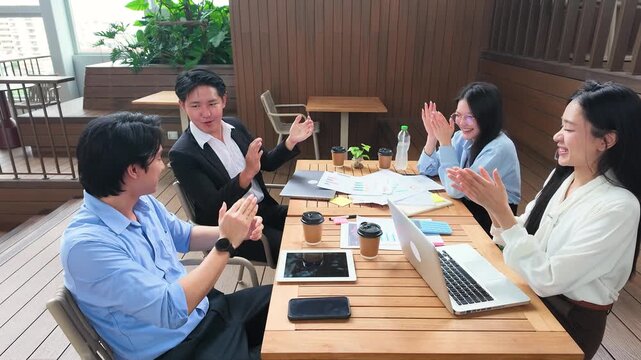Asian Business Team Celebrating Success with High Fives on Office Terrace