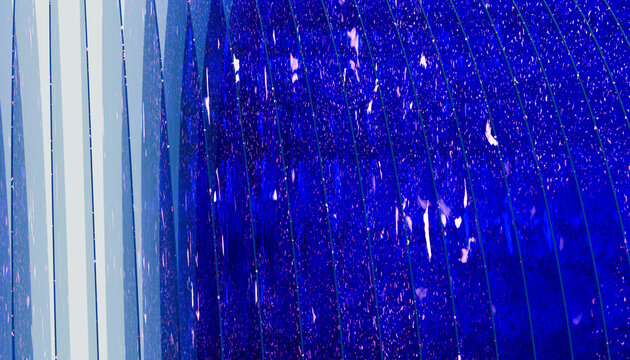 Blue glass panes with raindrops on modern architectural facade