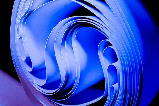 Abstract rendering of blue paper rolled into curved layered shapes
