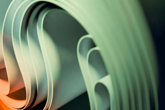 Abstract rendering of curved paper rolls with soft lighting