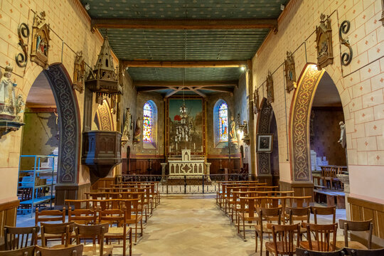 Wide view of a church nave with an ornate wooden pulpit, Gers, Saint Georges, France