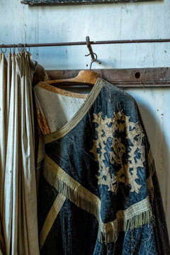 Antique embroidered liturgical vestment hanging on a wooden hanger, Gers, Saint Georges, France