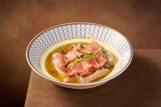 A bowl of preserved duck soup with vegetables