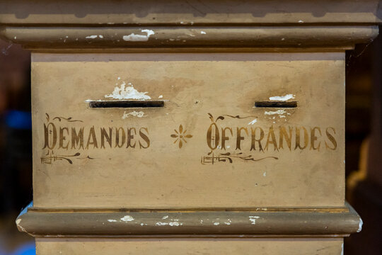 Detail of a wooden offertory box labeled Demandes et Offrandes, Gers, Saint Georges, France