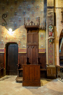 Wooden confessional booth beside a statue of a female saint with a lamb, Gers, Saint Georges, France
