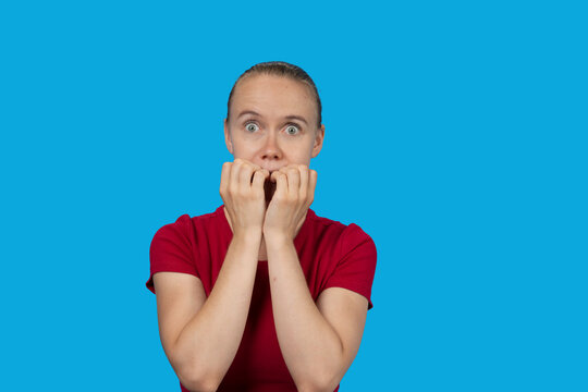 Woman biting nails expressing fear and anxiety