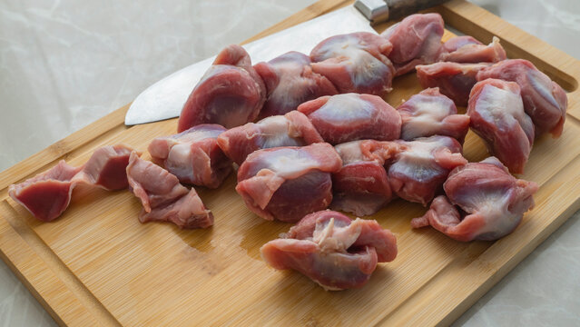 some chicken gizzards on a cutting board