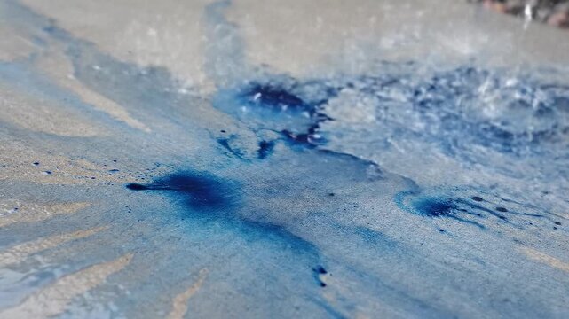 Water Stream Washing And Diluting Blue Ink Stains On Concrete