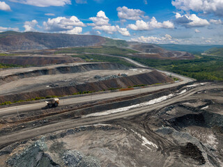 Obraz premium Open pit mine industry, big yellow mining truck for gold, copper ore, aerial view
