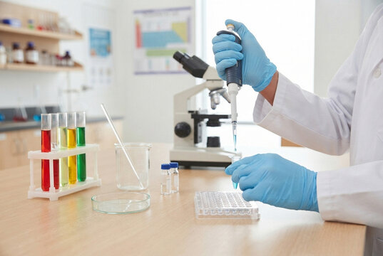 Scientist using pipette and microscope during chemical experiment in research laboratory.
