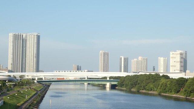 A static long-shot video of a building and a new transit system in Koto Ward, Tokyo.
