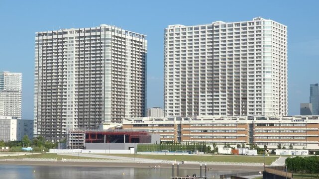 Footage panning from right to left across a cluster of buildings in Koto Ward, Tokyo.