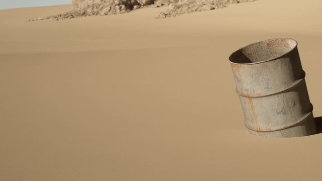 A weathered metal barrel is partially buried in a sand dune during the day. The scene shows a deserted, dry landscape with no plants or animals in sight.