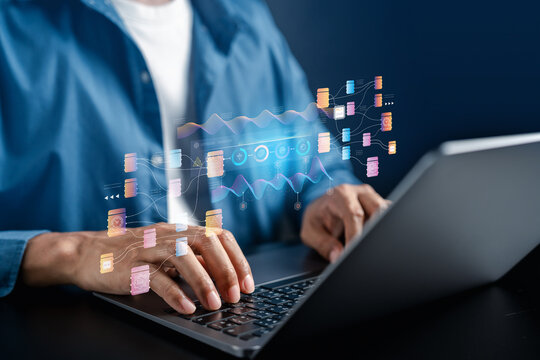 Big data machine learning data analysis and network architecture. Man typing on laptop computer keyboard with futuristic digital hologram node flowchart.