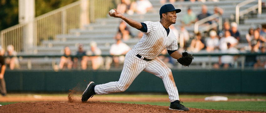 Pinstripe pitcher drives off mound during professional baseball game. Concept of power, speed, pitching mechanics and competition.