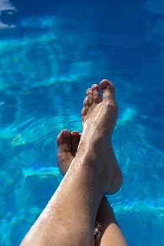 Woman's legs in the swimming pool