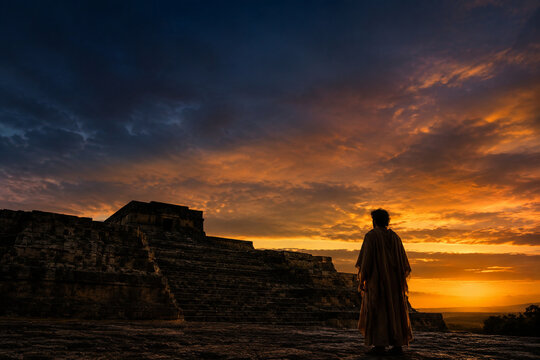 Lone figure before ancient ziggurat ruins at twilight, heritage and contemplation concept