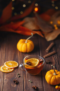 Autumn tea with orange cinnamon and star anise on a rustic wooden table