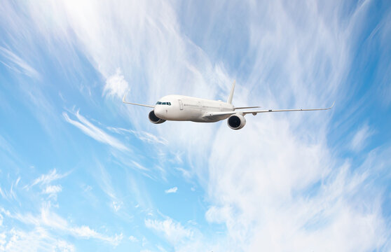 White passenger airplane flying in the sky amazing clouds in the background - An airplane shakes during turbulence flying air hole - A plane spinning in round clouds - Front view of an airplane 