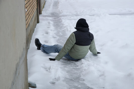 Winter Slip and Risk of Fall Accidents in Winter - a woman slips on an ice-covered road is a common winter hazard, leading to potential injuries