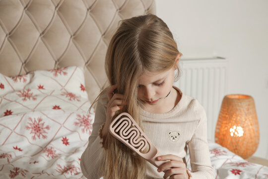 Little Girl with Long Blonde Hair Brushing Hair Before Bed