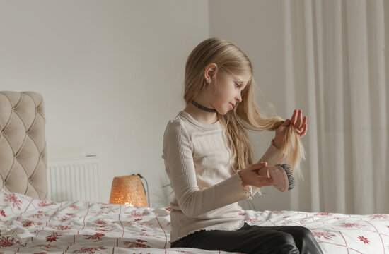 Little Girl with Long Blonde Hair Brushing Hair Before Bed