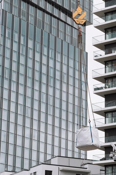 Modern glass facade and high rise architecture create a geometric urban composition with reflective windows and layered building details in daylight