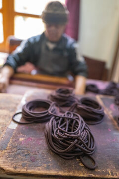 Coils of incense paste with an artisan working at Nado Poizokhang, Chang Gewog, Thimphu, Bhutan
