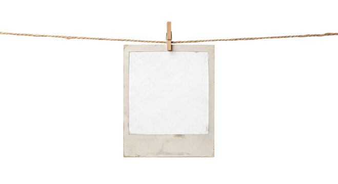 Vintage instant photo frame hanging on a twine line with a wooden clothespin