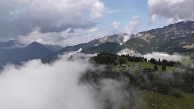 Alpine landscape nature rolling hills clouds covered Switzerland outdoor retreat
