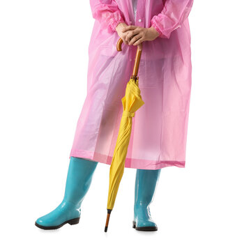 Rainy weather preparation and seasonal protection, person in pink raincoat and blue rubber boots holding a yellow umbrella isolated on white background