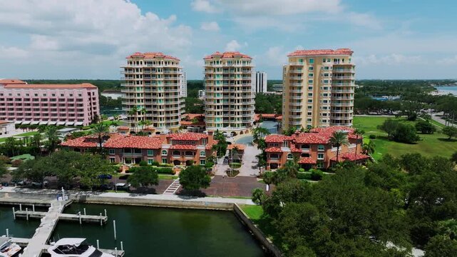 Aerial view of the elegant Villas of Bayfront Tower in downtown St. Petersburg, Florida, with Mediterranean-style architecture and views of the yacht basin beyond.
