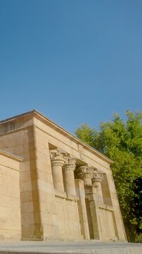 Low angle view of the Temple of Debod, an ancient Egyptian temple relocated to Madrid, Spain. Showcasing historic stone columns and architecture for travel and history documentaries.