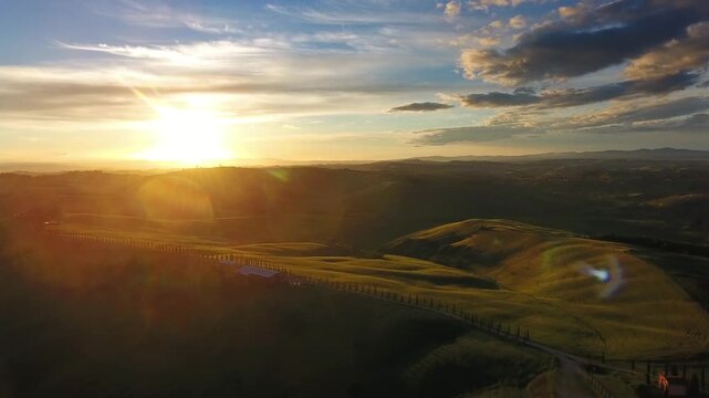 Aerial view of rolling hills at sunset in the countryside of Tuscany, Italy.