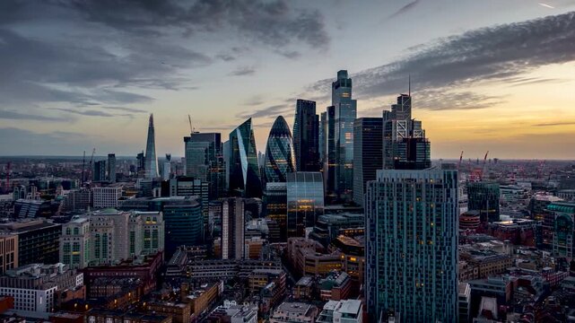 Aerial hyperlapse view of the office skyscrapers and the skyline at the City of London, England, during dusk