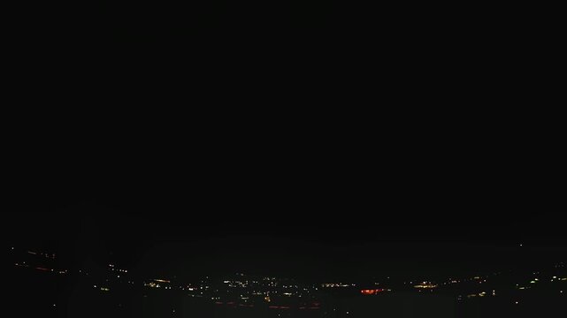 Flashes in the night sky above the city of Trento, Trentino, Northern Italy, during a thunderstorm