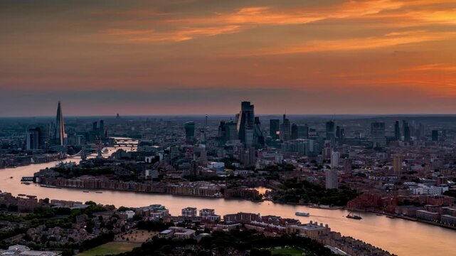 Fiery summer sunset to dusk time lapse view of the urban skyline of London, England, during a hot summer day