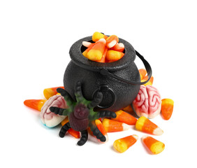 Cauldron of tasty candies for Halloween isolated on white background, closeup